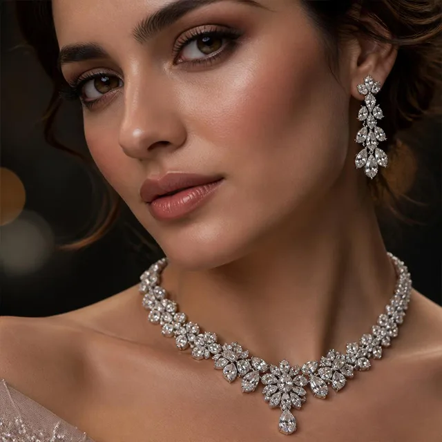 Close-up of a woman wearing a diamond necklace and matching drop earrings